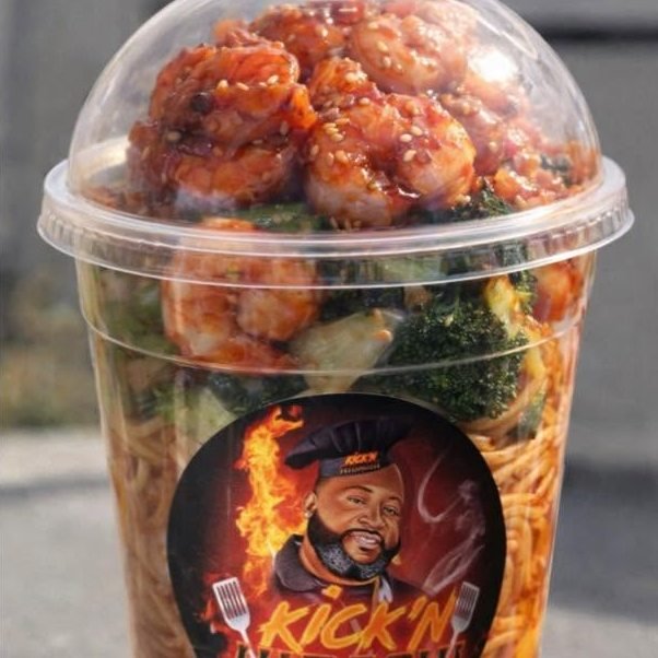 Tall domed cup layered with fried rice, noodles, broccoli and sesame-glazed shrimp